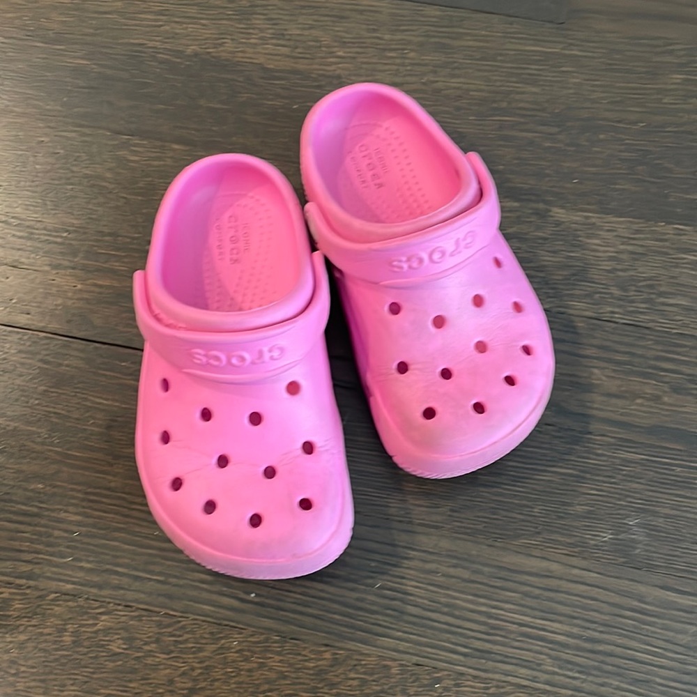 Dark pink size 11 little girl crocs. Gently used. Minor scuffs from basic wear.